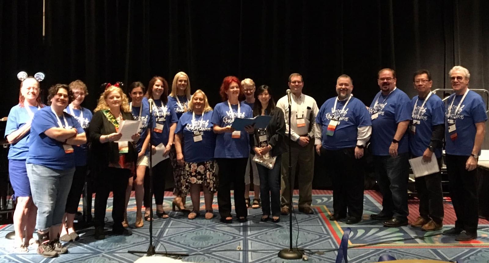 The choir gathered on a conference stage with past leader Darrel Pearson.